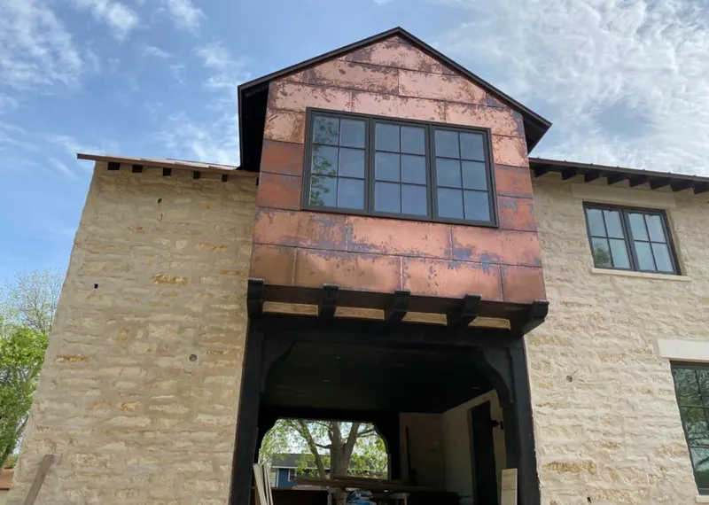 Copper metal panel facade on a stone building for Skylight Installation in Philomath